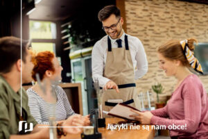 kelner w niemieckiej restauracji doradzający gościom w wyborze dania niemiecki w restauracji nauka słownictwa Preston Publishing