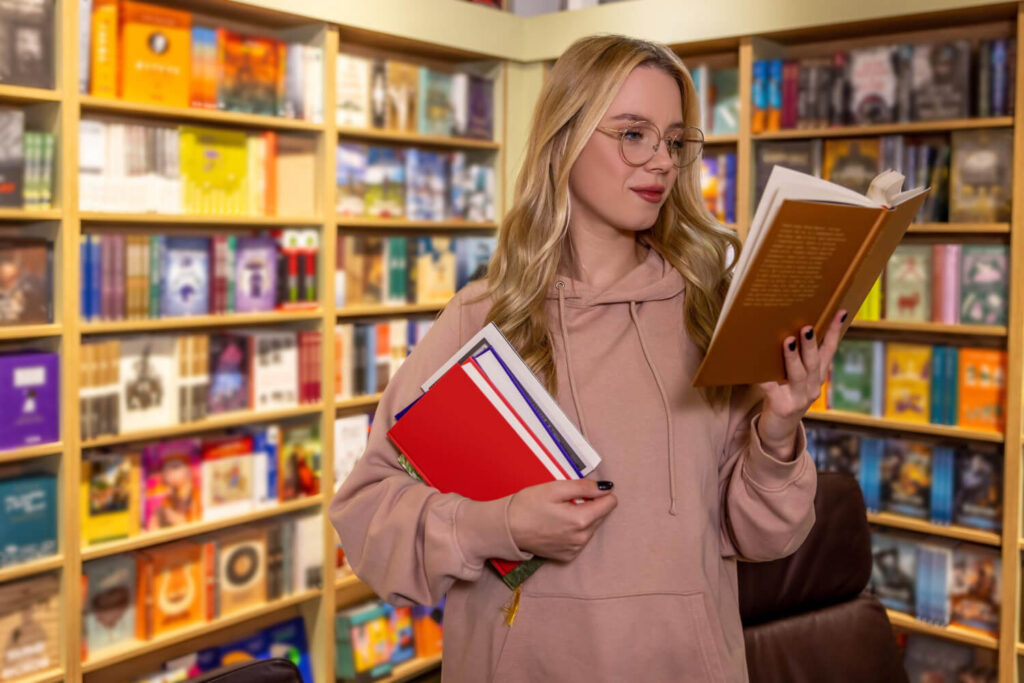 dziewczyna wybierajaca w ksiegarni ksiazki do nauki jezyka angielskiego przez czytanie Preston Publishing